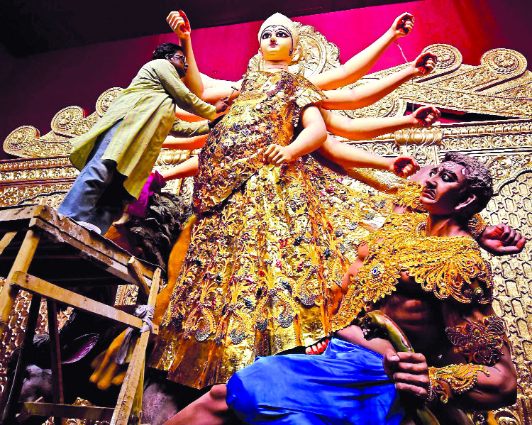 Bedecked in gold sari Maa Durga draws huge crowds