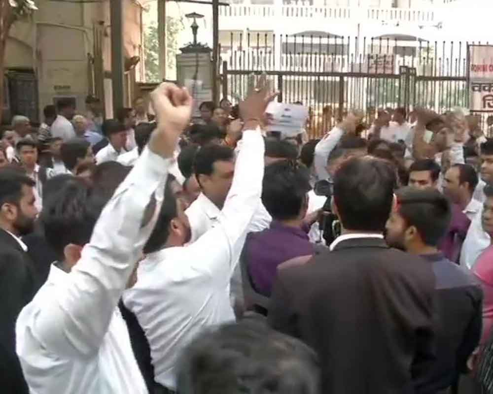 Angry lawyers gather outside district courts in Delhi