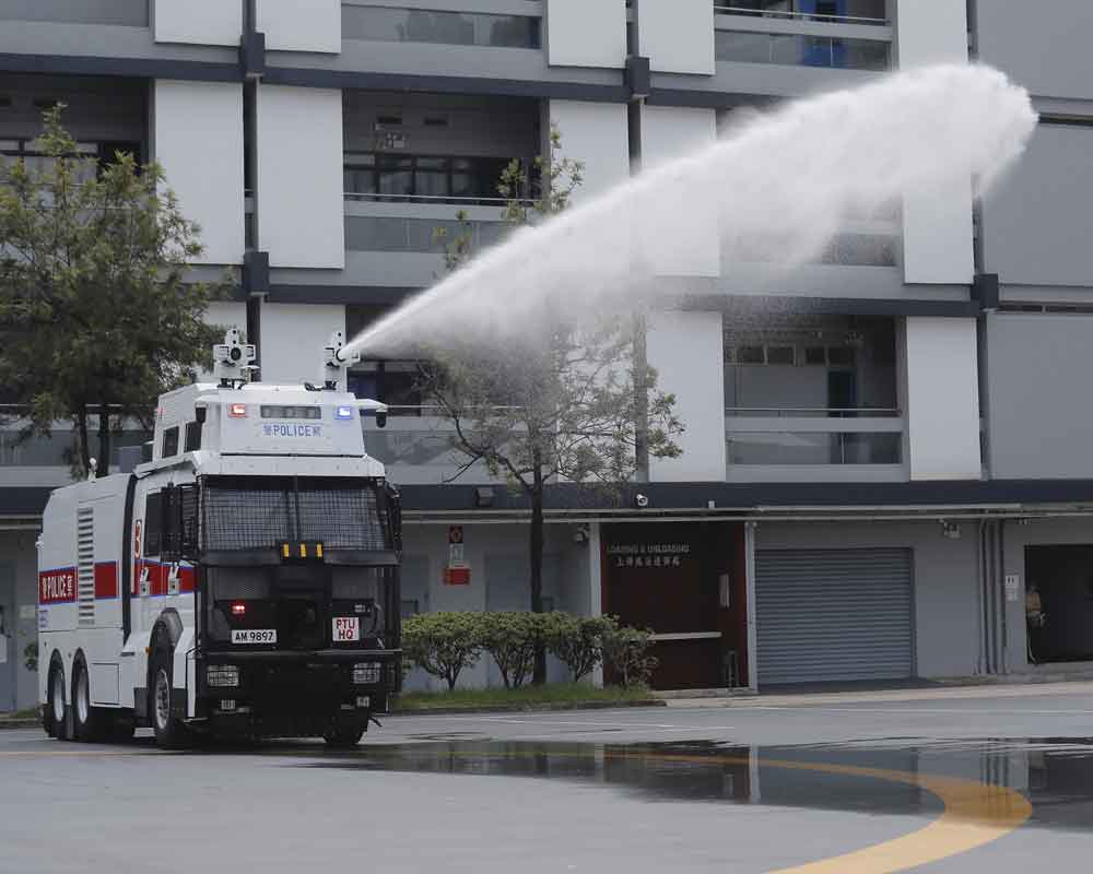 Hong Kong police demonstrate water cannon as protests linger