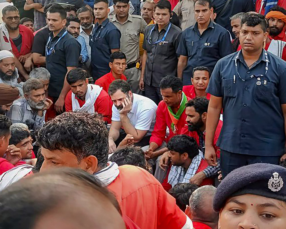 Rahul Gandhi interacts with porters at Anand Vihar railway station