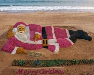 Santa Claus sculpture created with sand, onions on Puri Beach