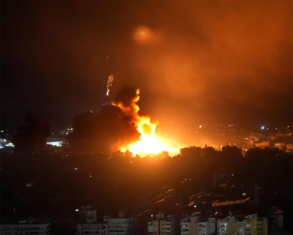 Israeli airstrikes rock southern suburbs of Beirut and cut off key crossing into Syria