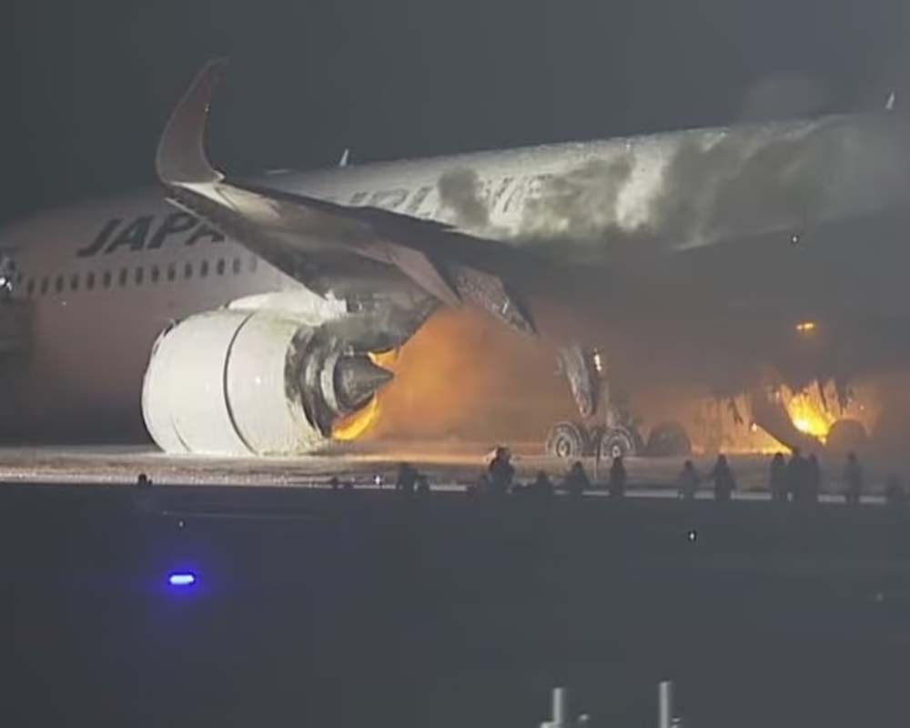Plane catches fire on runway at Japan's Haneda airport
