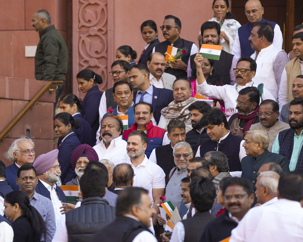 Small tricolour, red rose in hand, Oppn MPs urge govt to run House