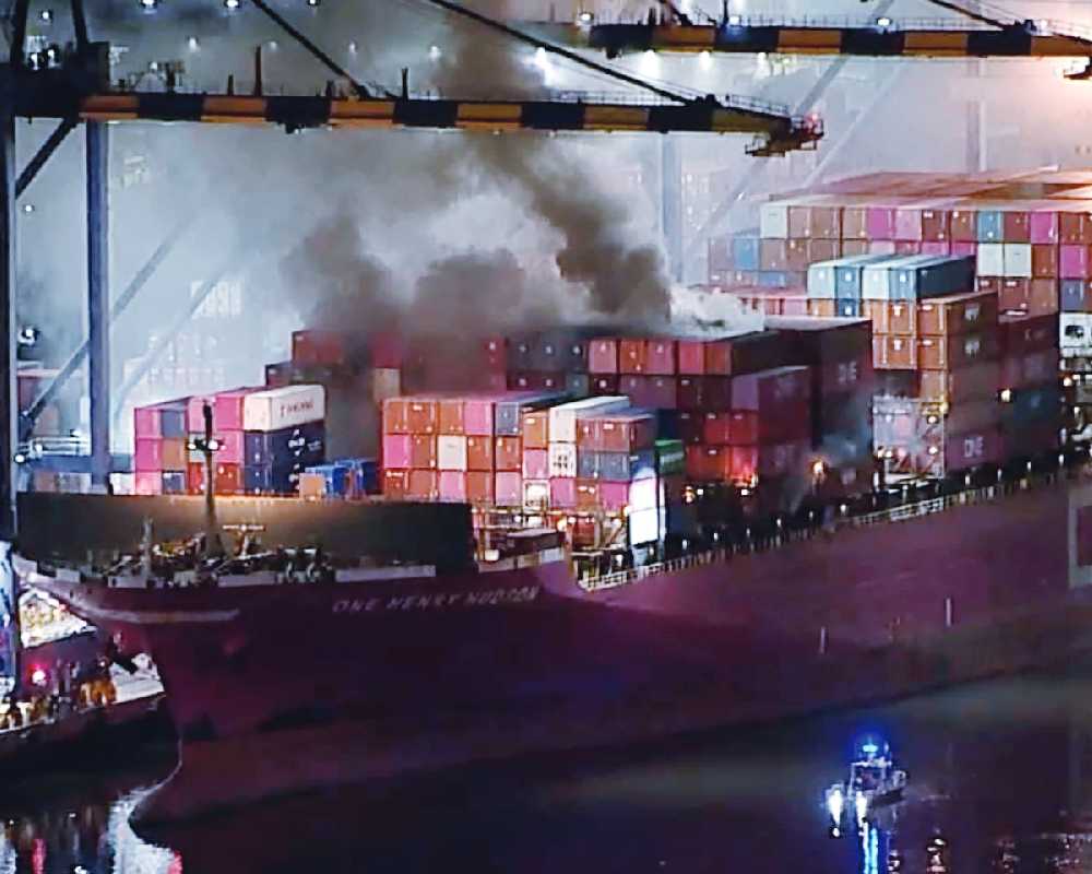 Dozens of firefighters battle blaze on container ship