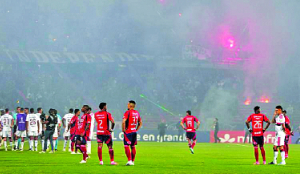 Copa Libertadores game stopped early as fans protest with flares