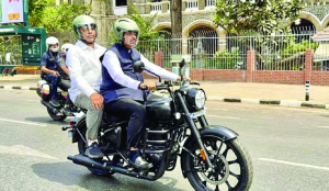 Fadnavis rides bike to house, defends PM’s austerity call