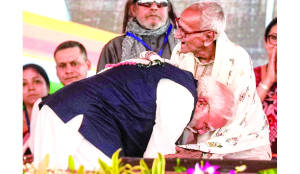 PM touches feet of BJP veteran at swearing-in