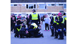 Police officers bitten during anti-migrant protests in UK town