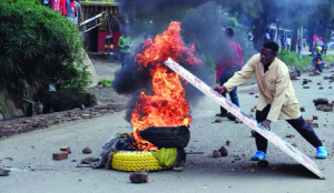 Protesters light bonfires during public transport strike in Kenya over fuel prices