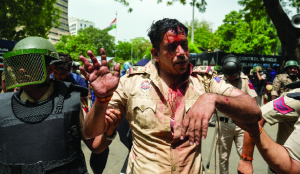 Tear gas fired, officers injured as violence erupts minutes before Pradhan’s resignation