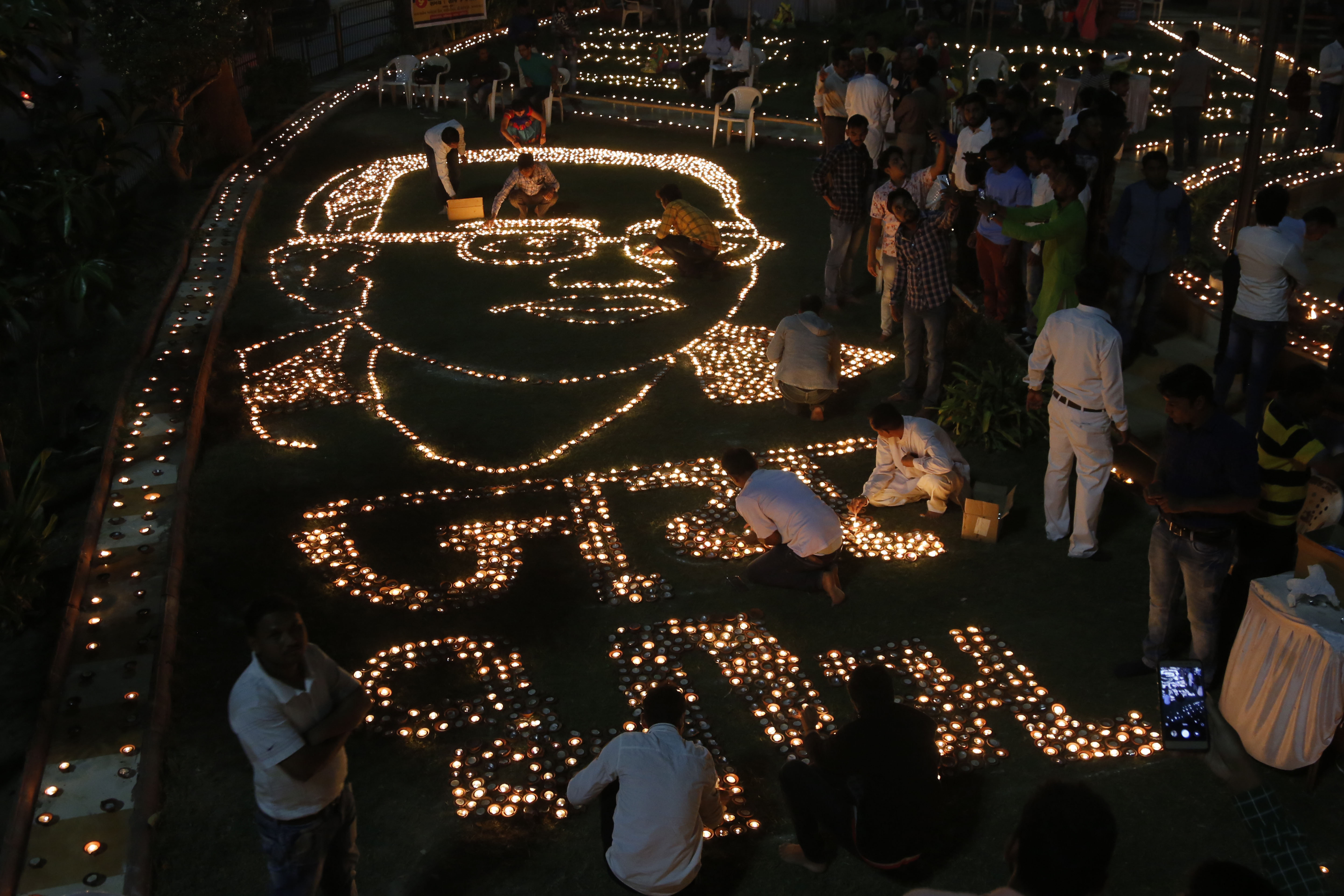 Indians makes formation of Bhim Rao Ambedkar with earthen lamps to mark Ambedkar's death anniversary in Ahmadabad - AP