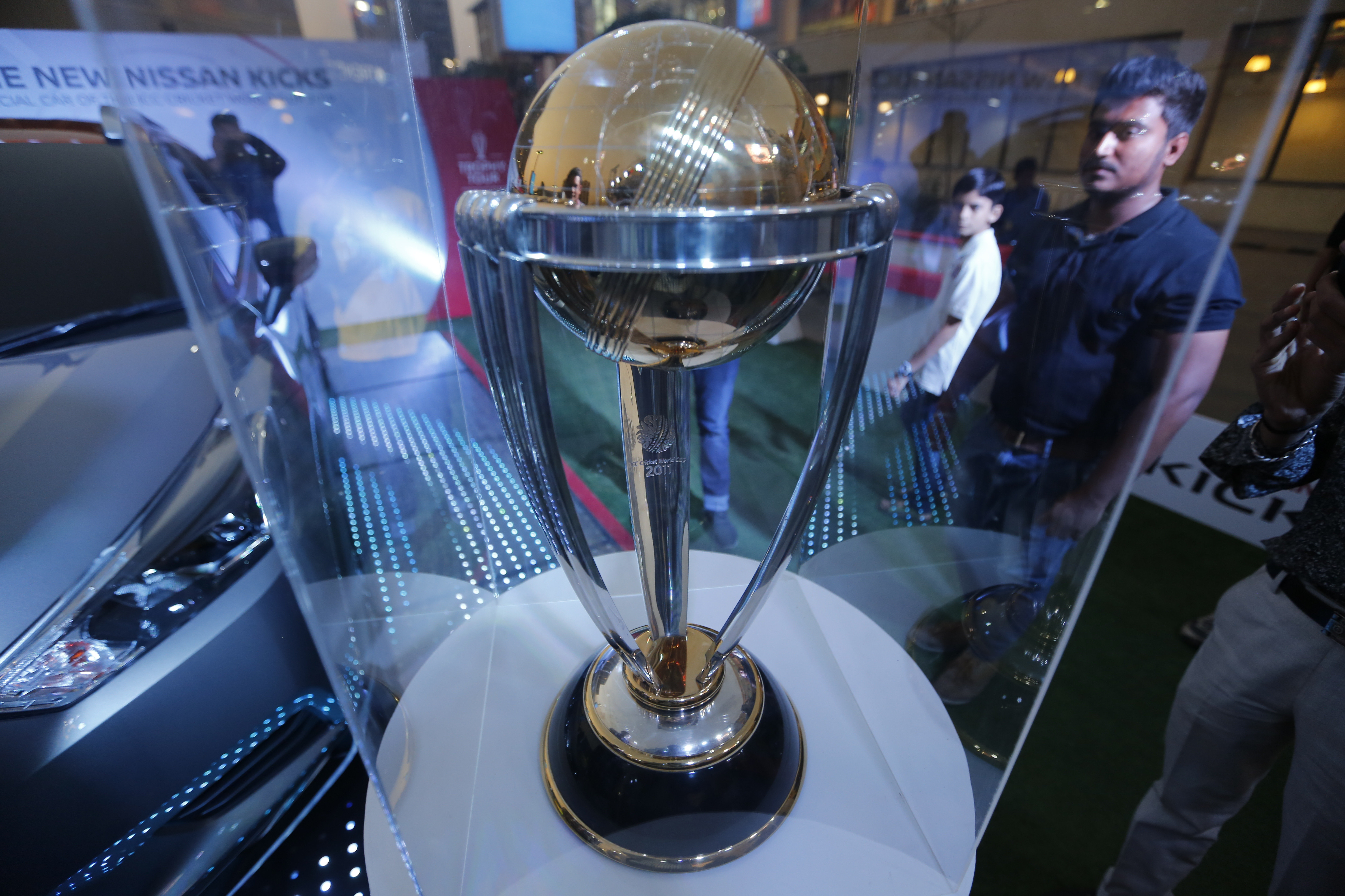 Indian youth look at an ICC Cricket World Cup 2019 Trophy displayed at a mall in Ahmadabad - AP