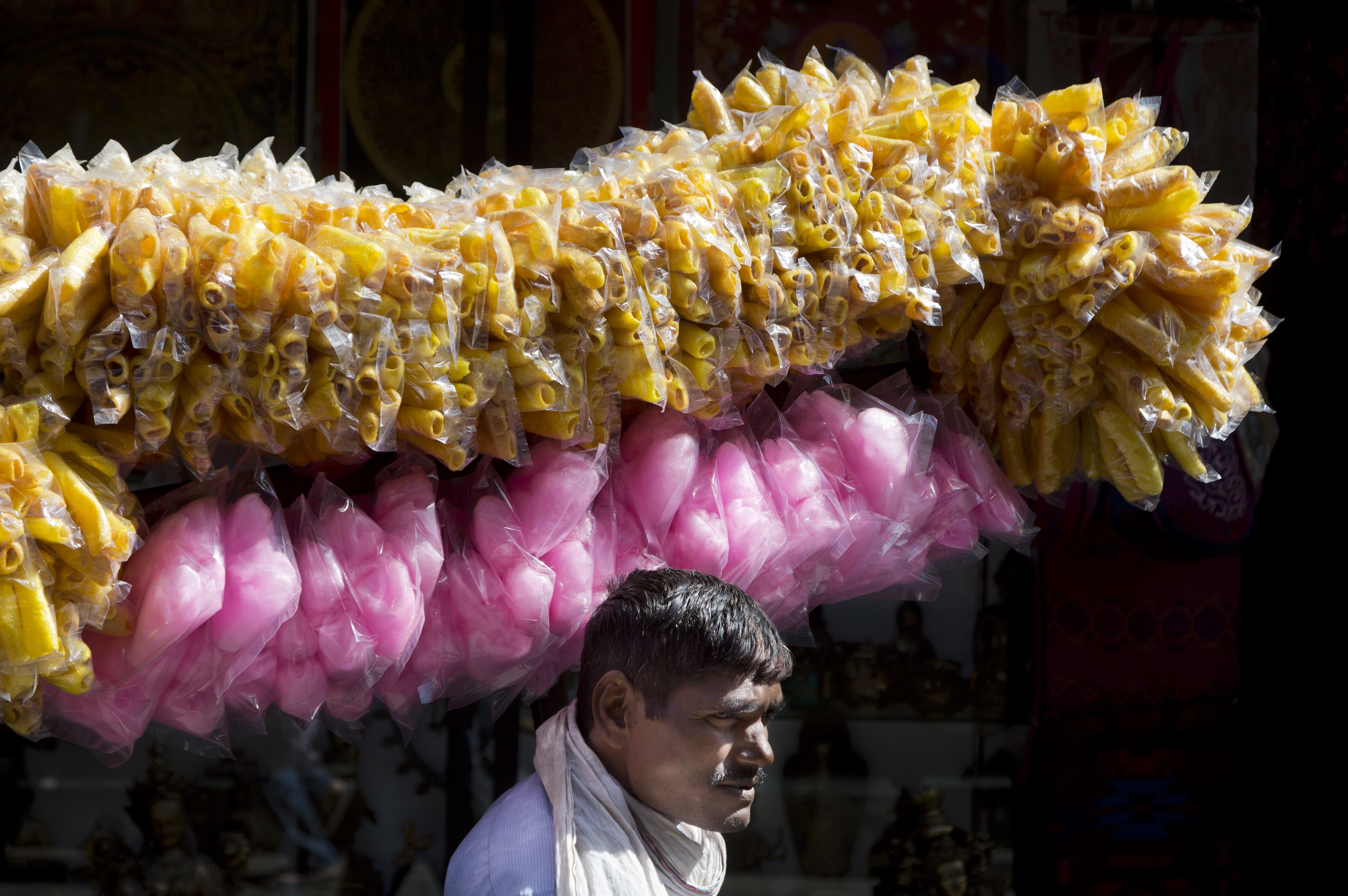 A vendor sells crips and candy floss in Dharmsala - AP