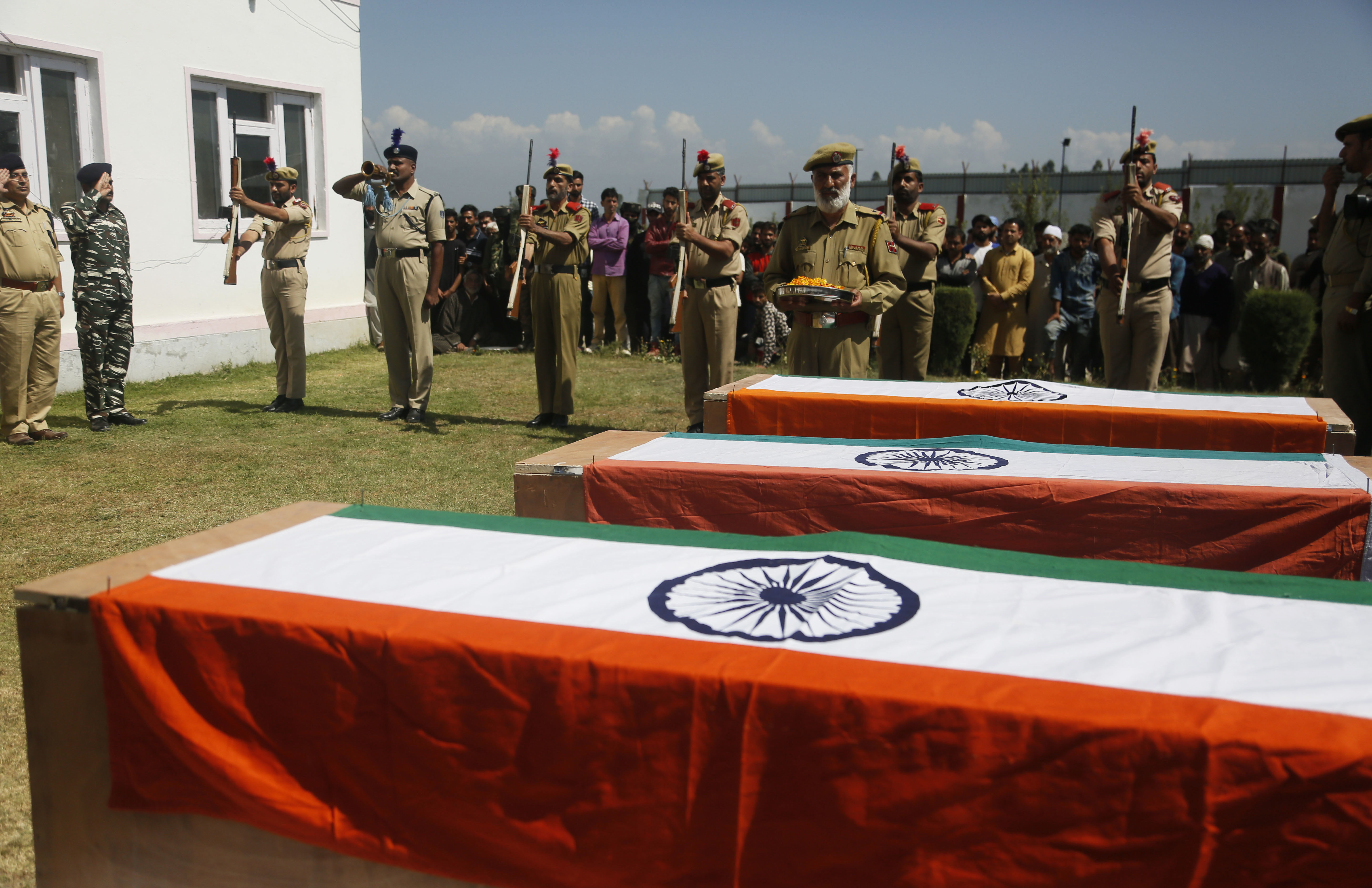 Indian police officers pays respects to colleagues who were killed by rebels, during a wreath laying ceremony at a base camp at shopian - AP