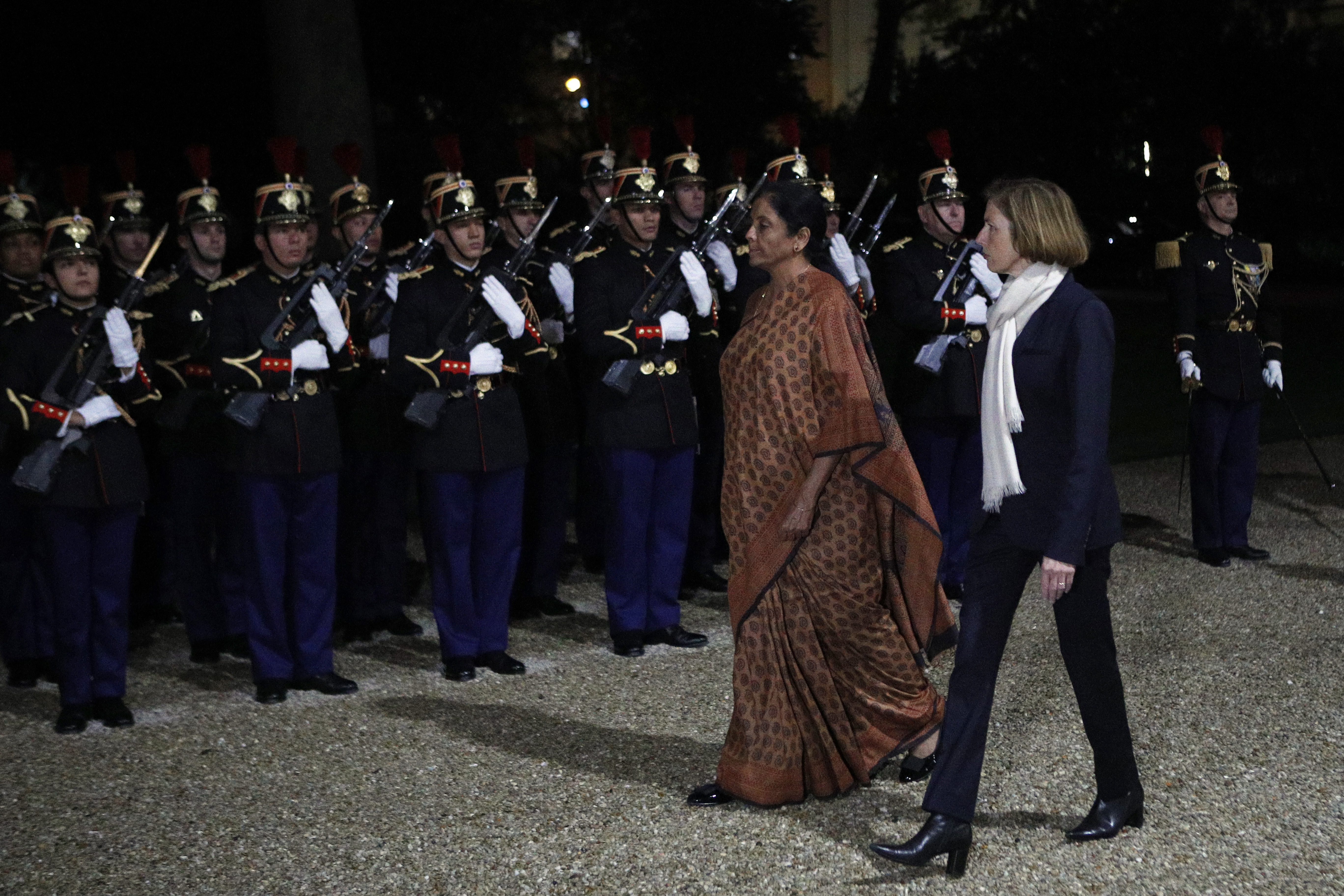 French defense minister Florence Parly, right, reviews French Republican Guards with India's defense minister Nirmala Sitharaman prior to their meeting at Hotel de Brienne Defense ministry in Paris - AP