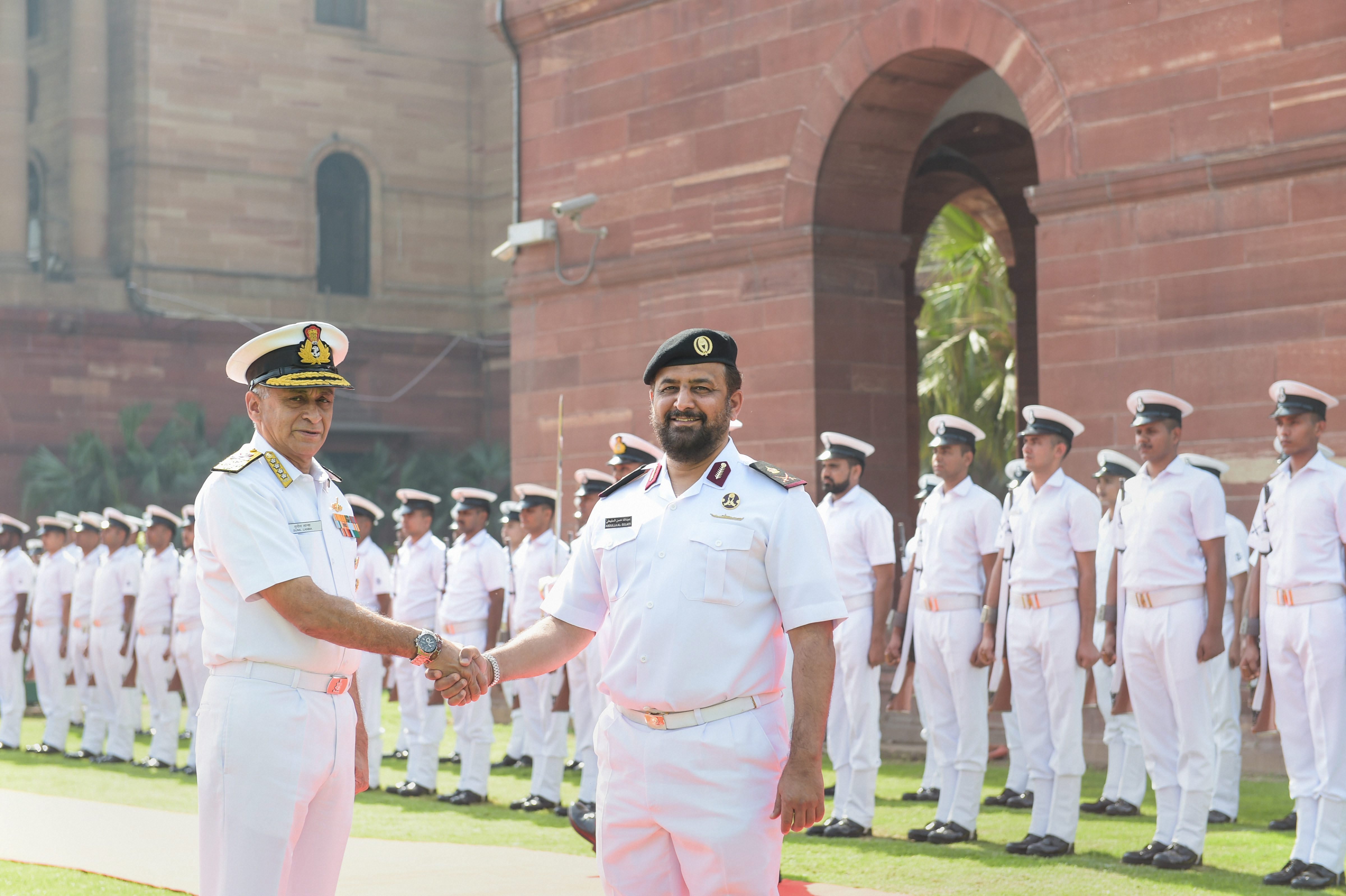 Indian Navy Chief Admiral Sunil Lanba shakes hands with Commander Qatar EMIRI Naval Forces Staff Major General Abdullah Bin Hassan Al Sulaiti, during guard of honour at South Block, in New Delhi - PTI