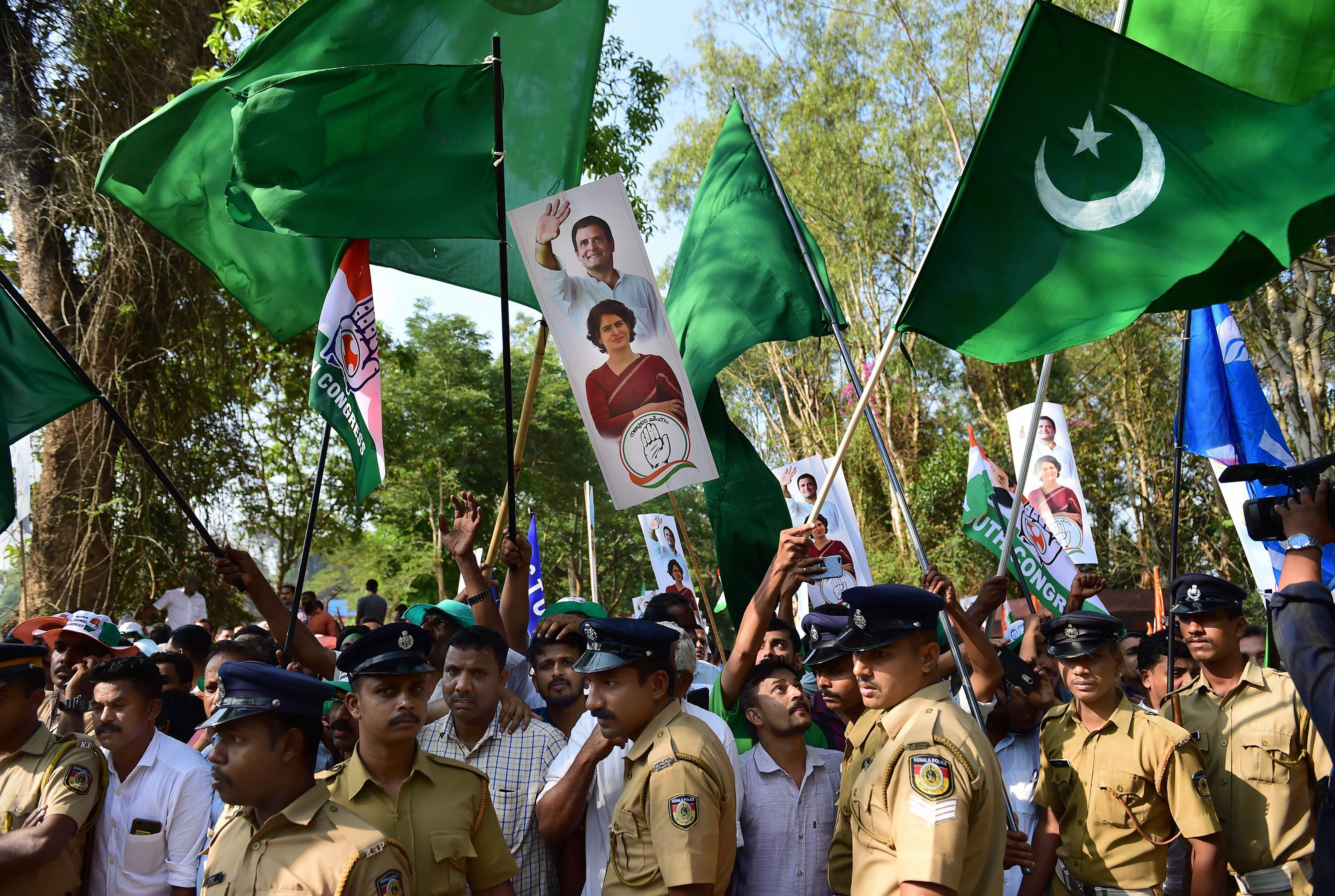 Indian Union Muslim League (IUML) supporters, with green flags, join supporters of Congress as they wave flags prior to the filing of nomination papers by Congress President Rahul Gandhi, in Wayanad - PTI