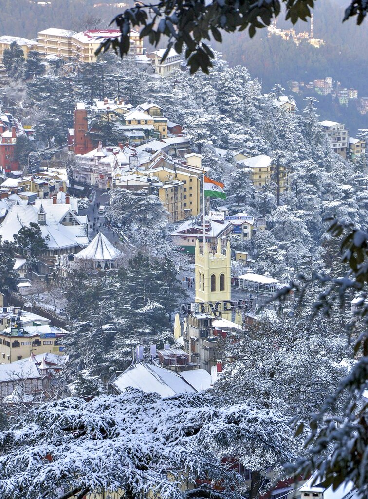 A view of snow-laden city following fresh snowfall on a cold, winter morning, in Shimla - PTI