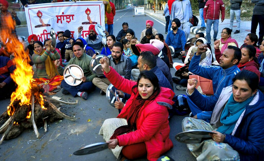 Protesting members of Sanjha Adhiyapak Morcha Punjab protest outside CM's residence, in Patiala - PTI