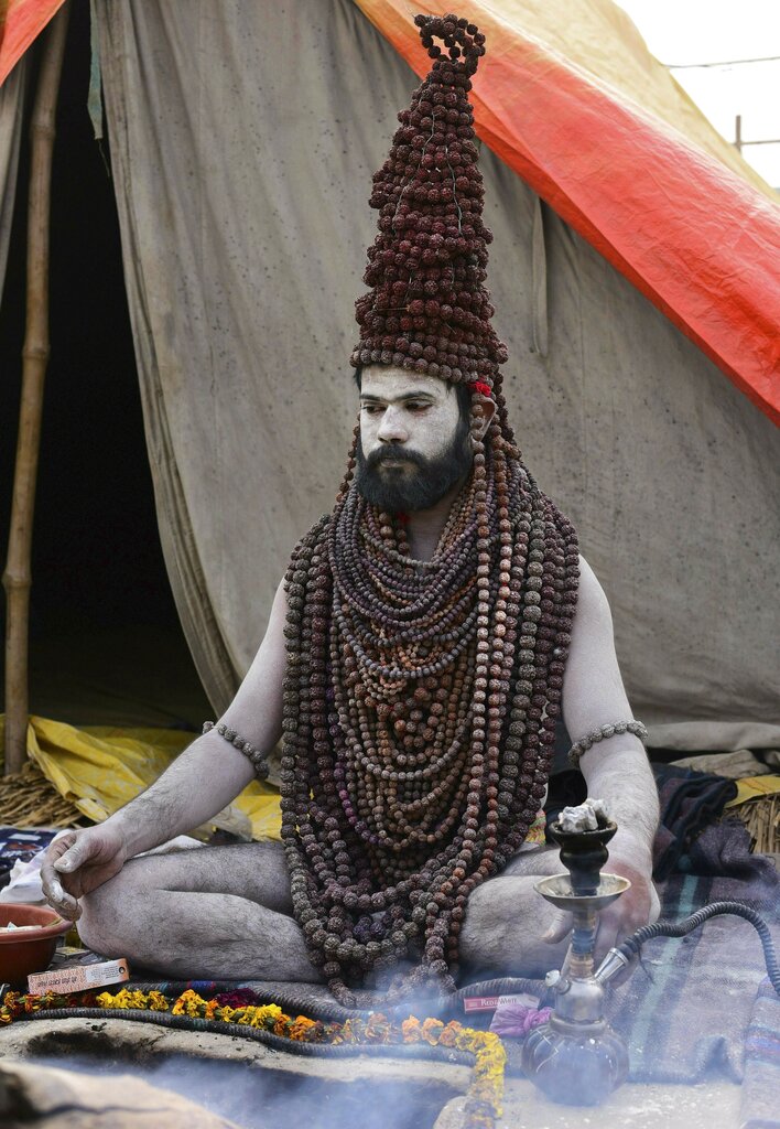 A ssdhu wears rudraksh garland at the bank of river Ganga on the eve of Makar Sankranti for upcoming Kumbh Mela-2019, in Allahabad - PTI