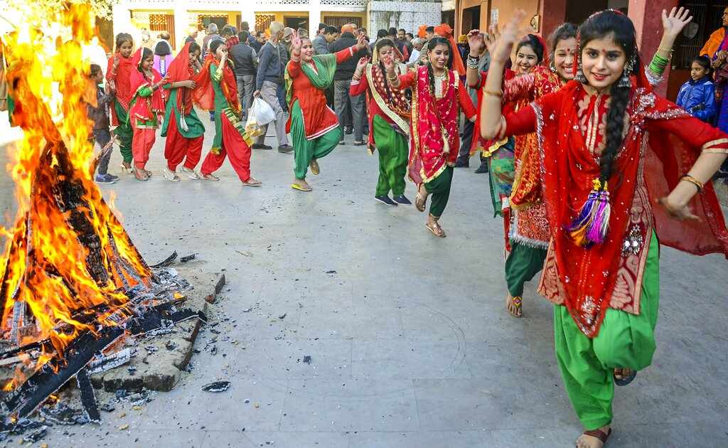 Young girls dressed in traditional attire celebrate Lohri festival, in Jammu - PTI