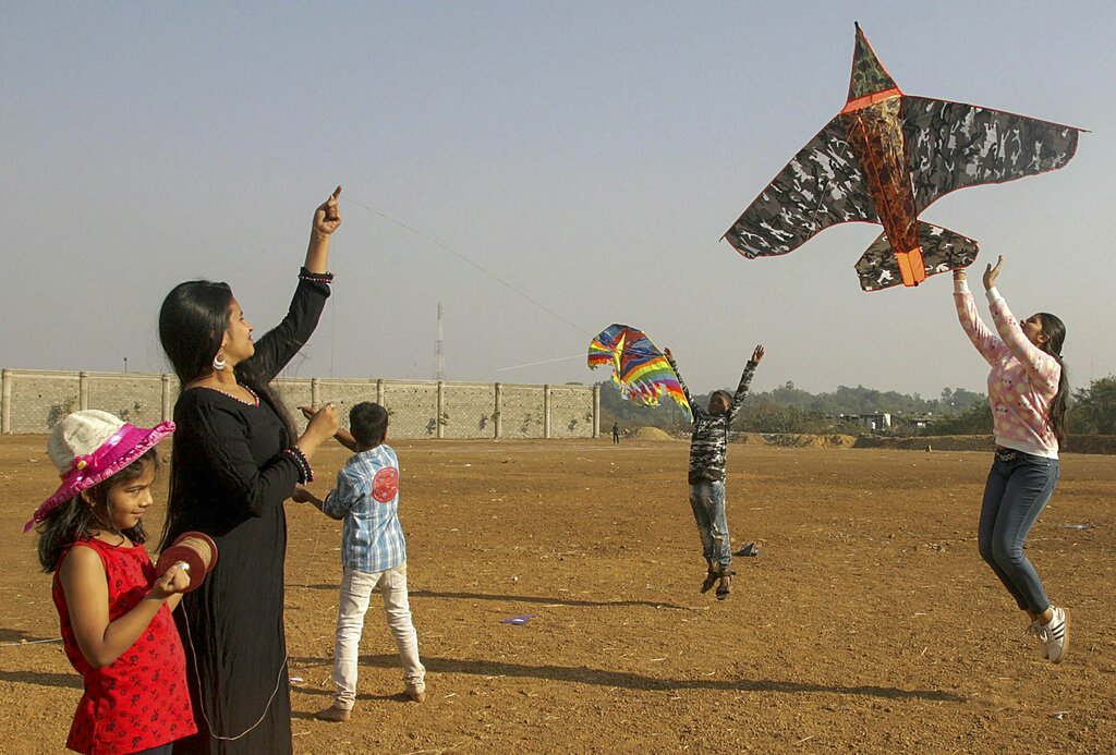 People fly kites on the eve of Makar Sakranti festival, in Mumbai - PTI