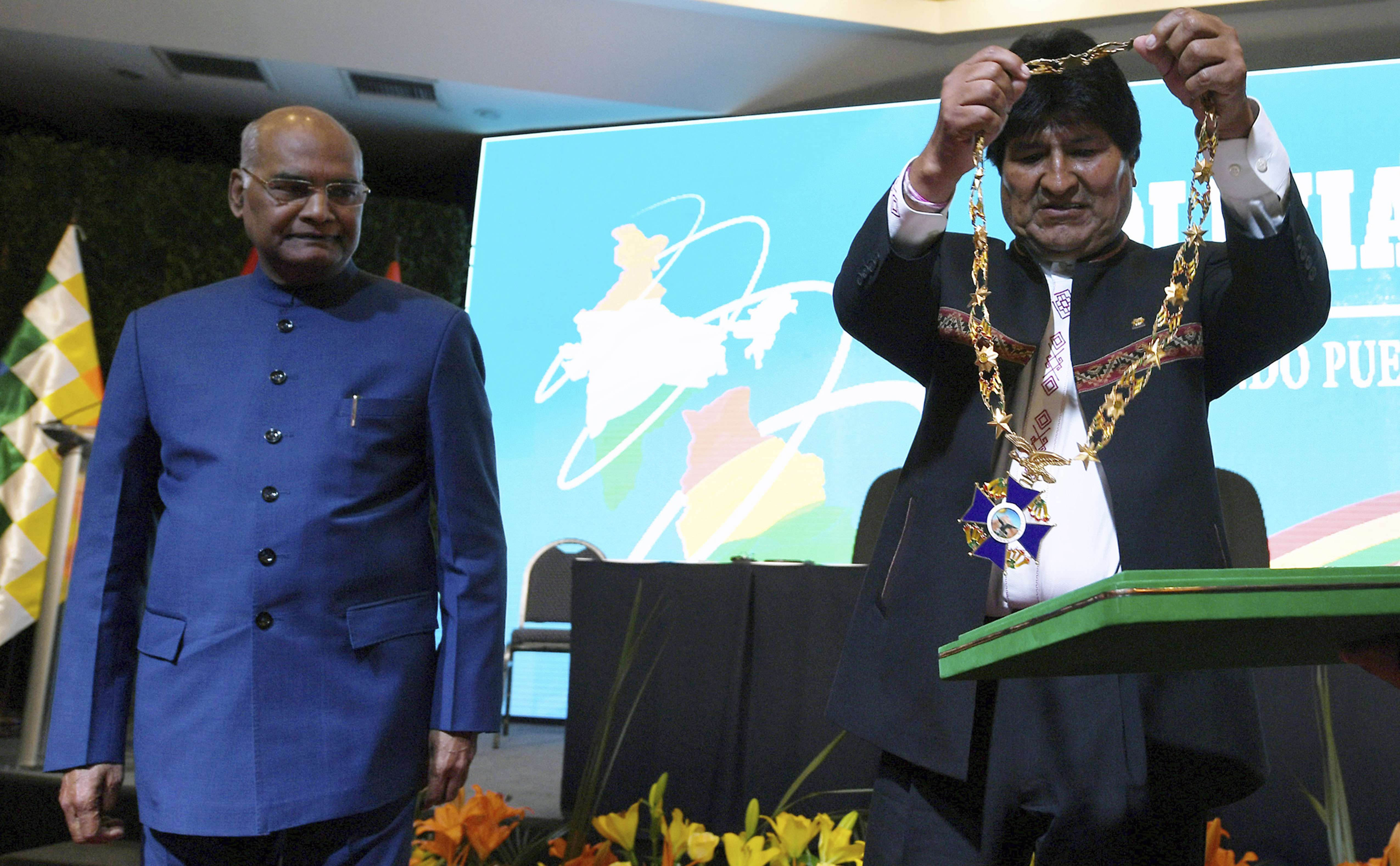 Bolivia's President Evo Morales prepares to decorate India's President Ram Nath Kovind with La Gran Cruz del Condor de Los Andes, in Santa Cruz, Bolivia - AP