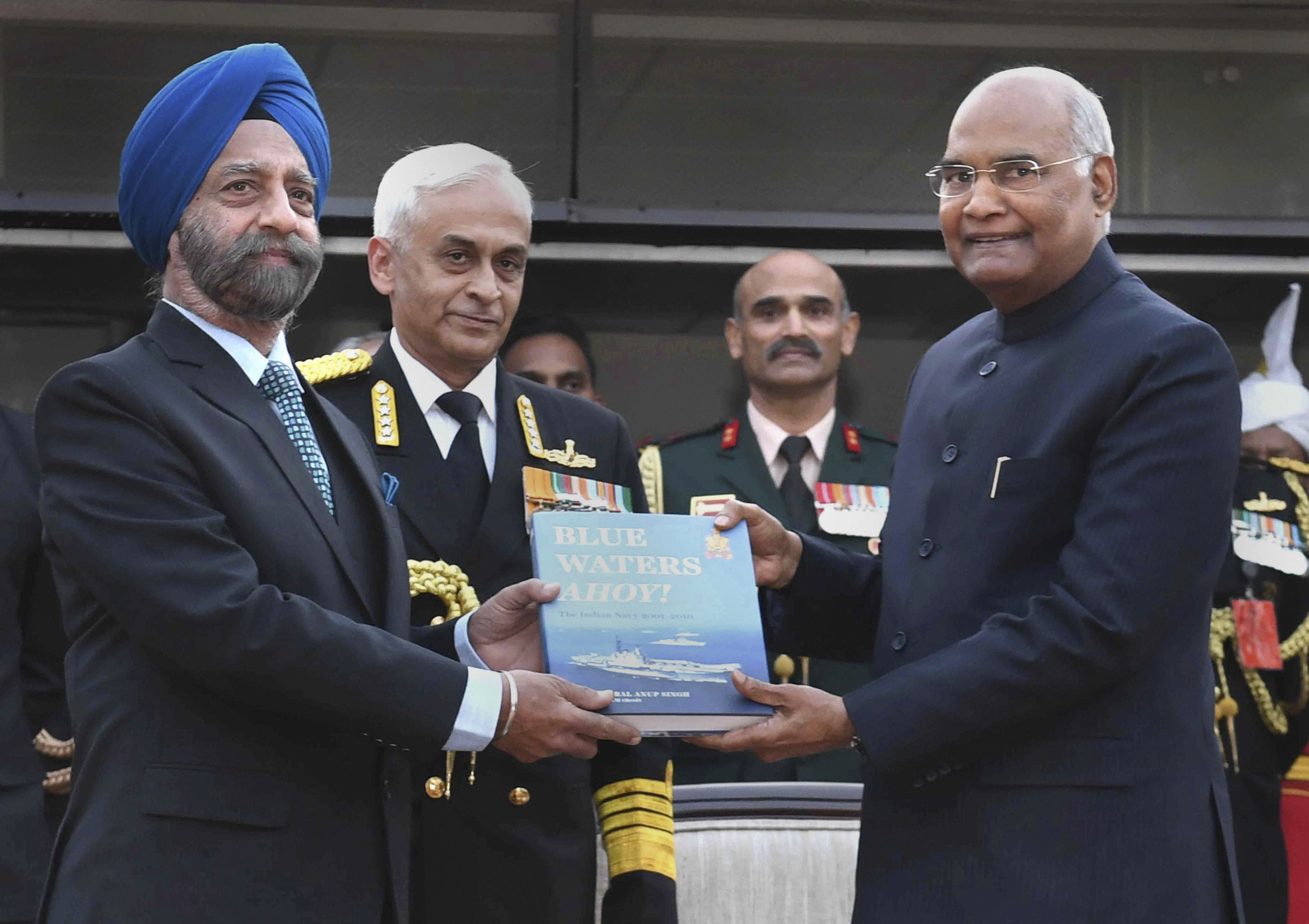 President Ram Nath Kovind along with Navy chief Admiral Sunil Lanba releases a publication during the Navy Day reception, in New Delhi - PTI