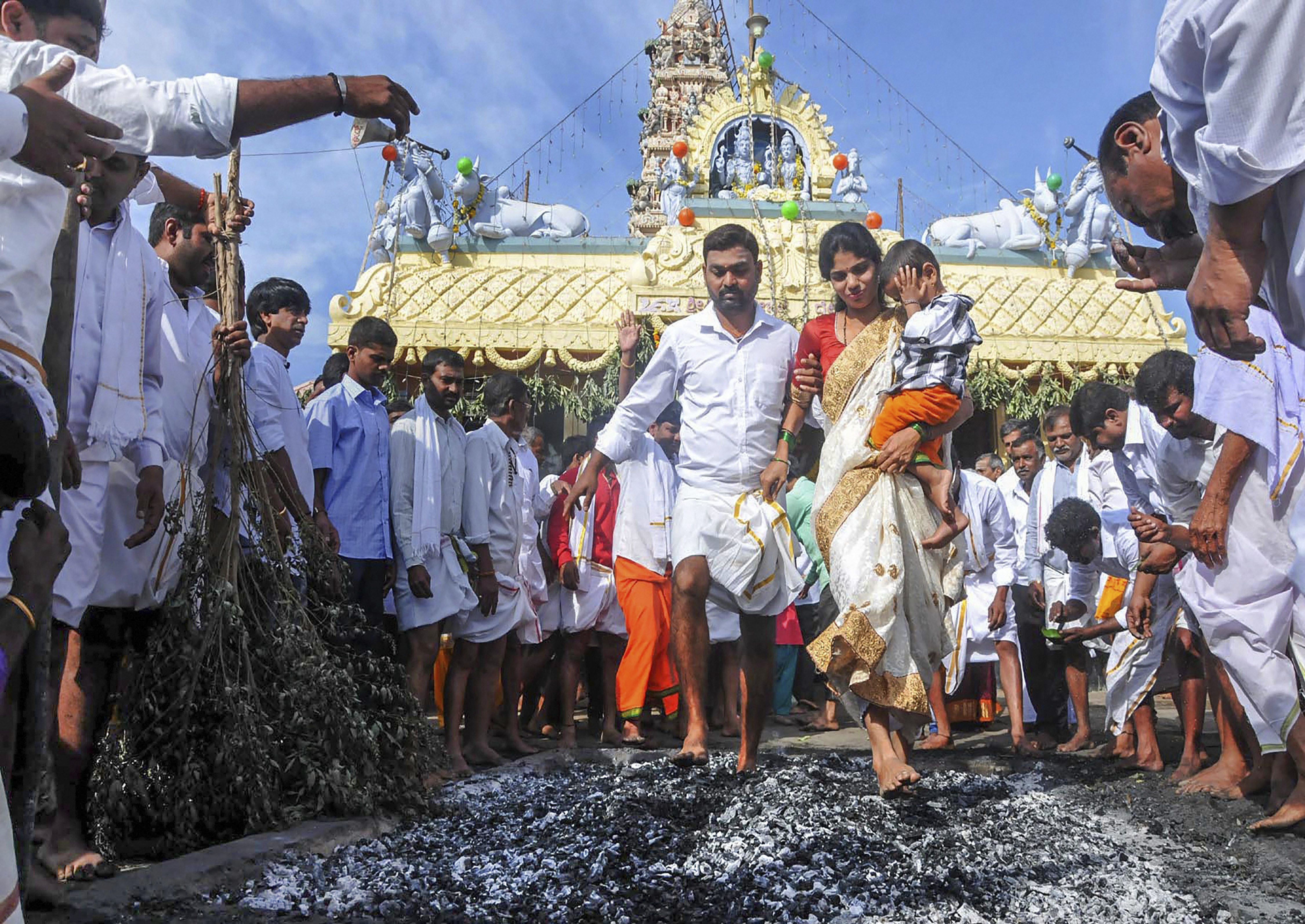 Devotees walk on embers during Sri Veerabhadreshwara Swamy Kendotsava in Chikmagalur, Karnataka - PTI