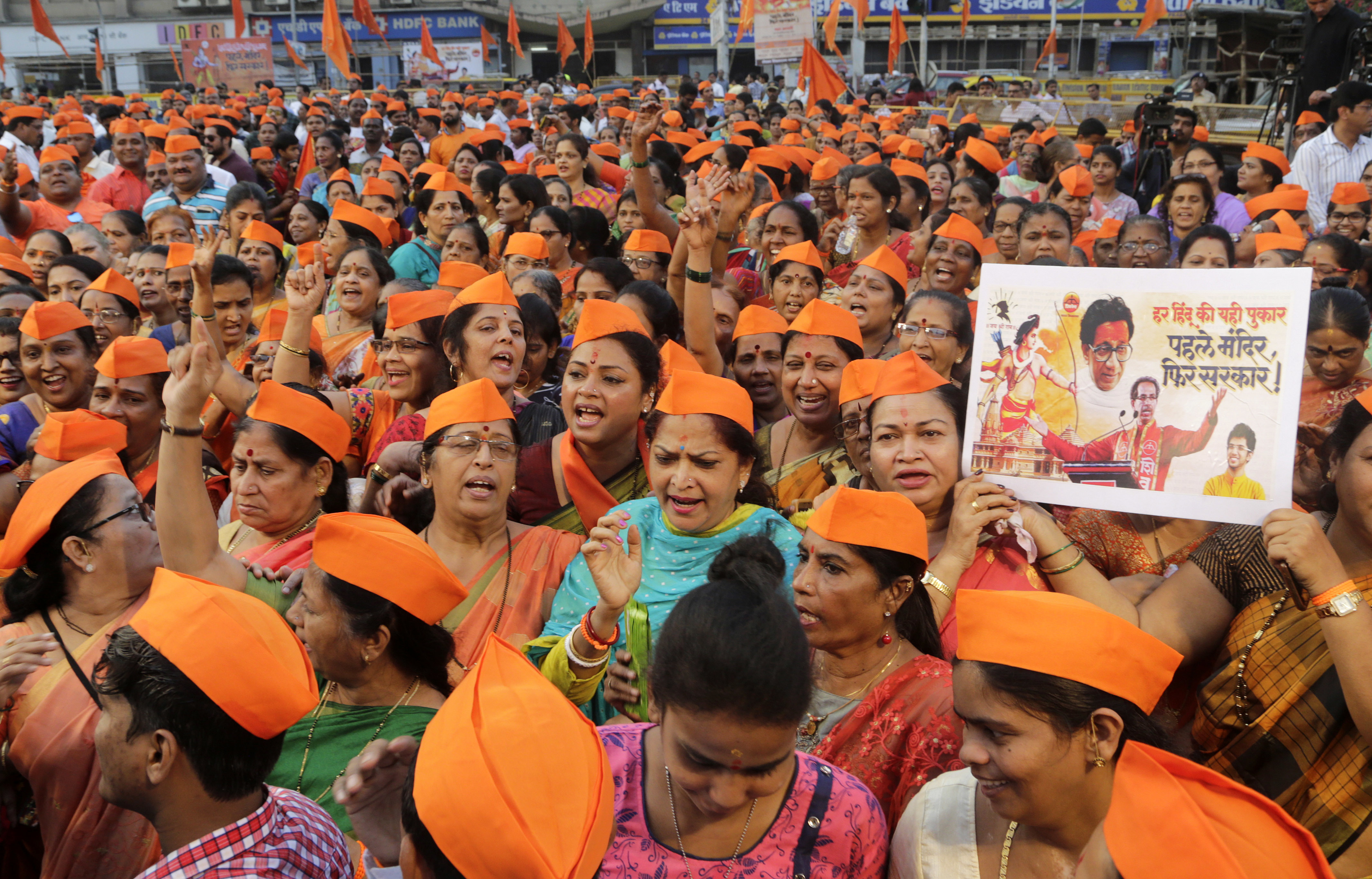 Activists of Hindu nationalist Shiv Sena party shout slogans during a gathering organized to demand the Rama temple be built at Ayodhya, in Mumbai - AP