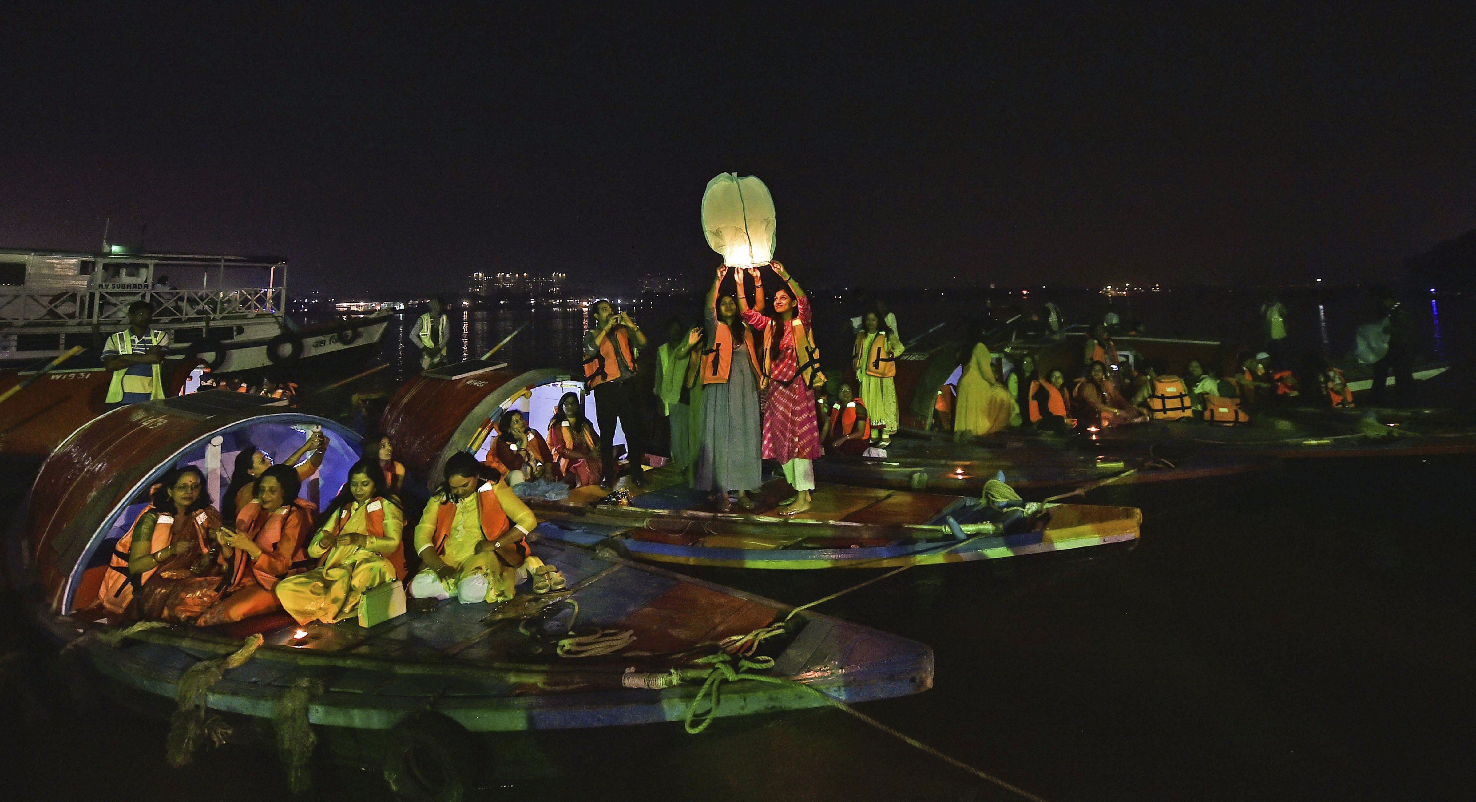 Hindu devotees release sky lanterns to mark Dev Deepawali festival, in Kolkata - PTI