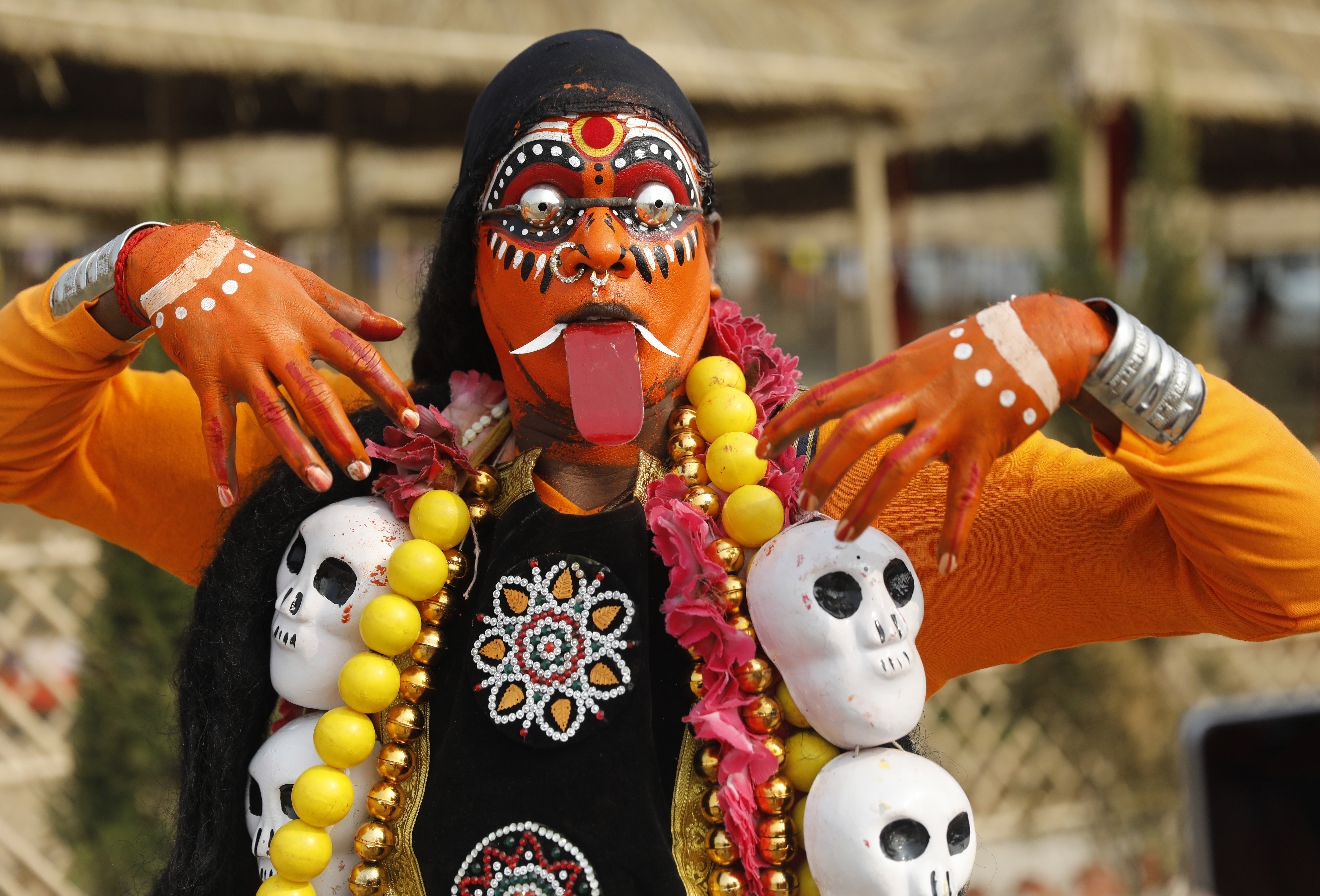 An Indian artist performs a dance dedicated to the goddess of destruction Kali at the Sangam, the confluence of rivers Ganges, Yamuna and the mythical Saraswati, during the Kumbh Mela in Prayagraj - AP