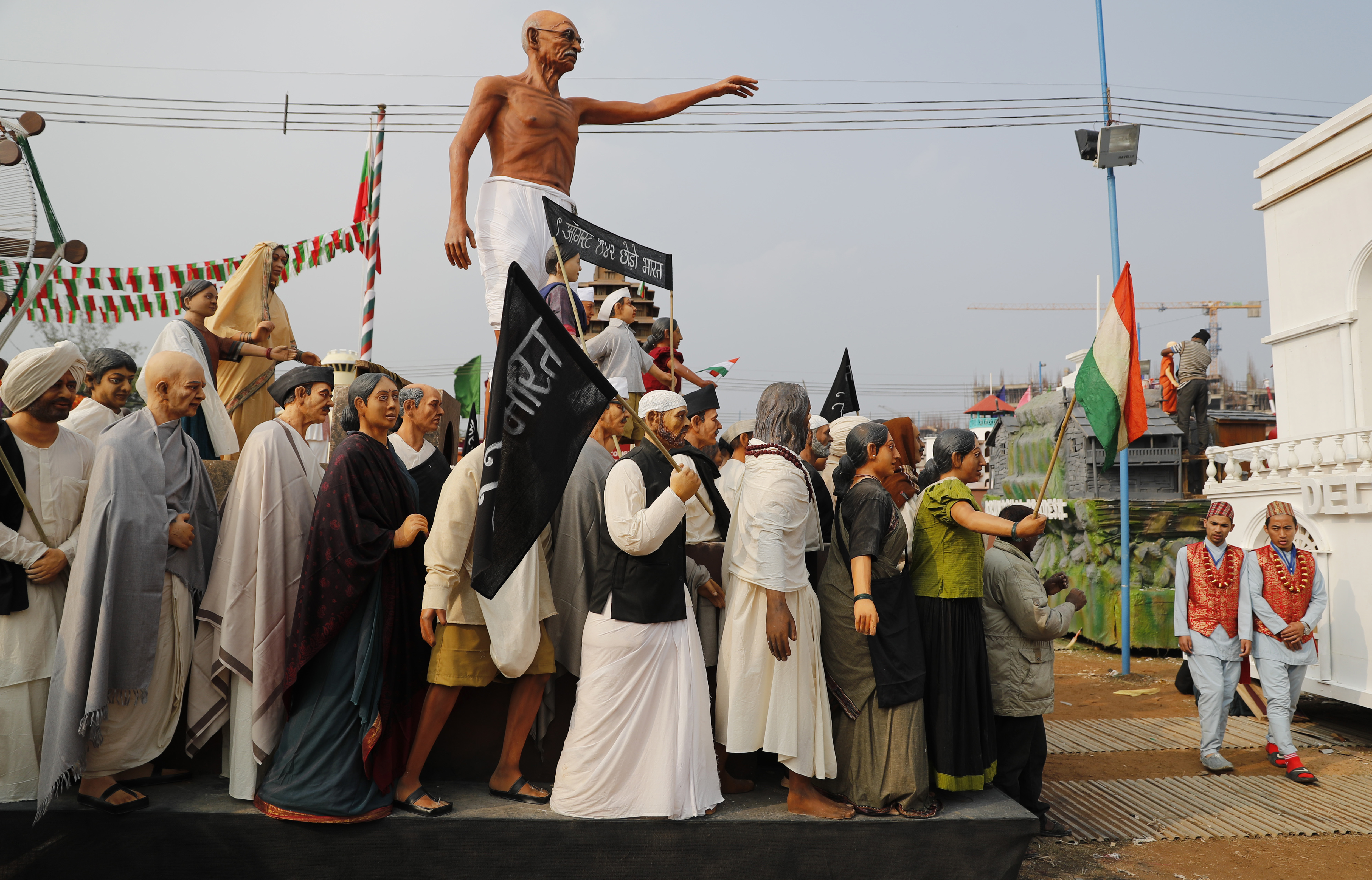 A statue of Mahatma Gandhi stands tall on a tableaux depicting a scene of India's pre-independence era during a media preview displaying a glimpse of culture of different parts of India, in New Delhi, India - AP