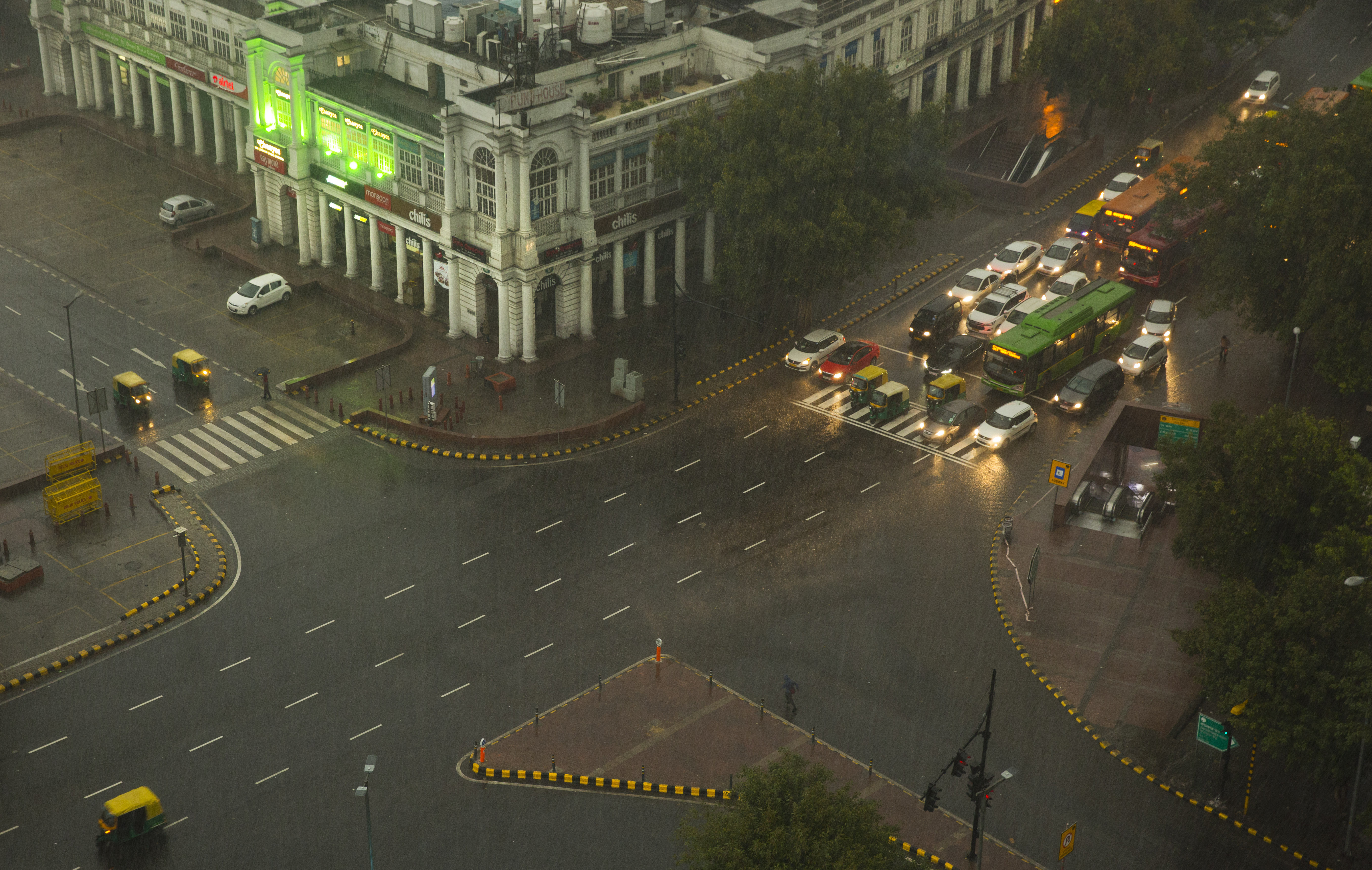 Vehicles wait at an intersection during a rainstorm in New Delhi - AP