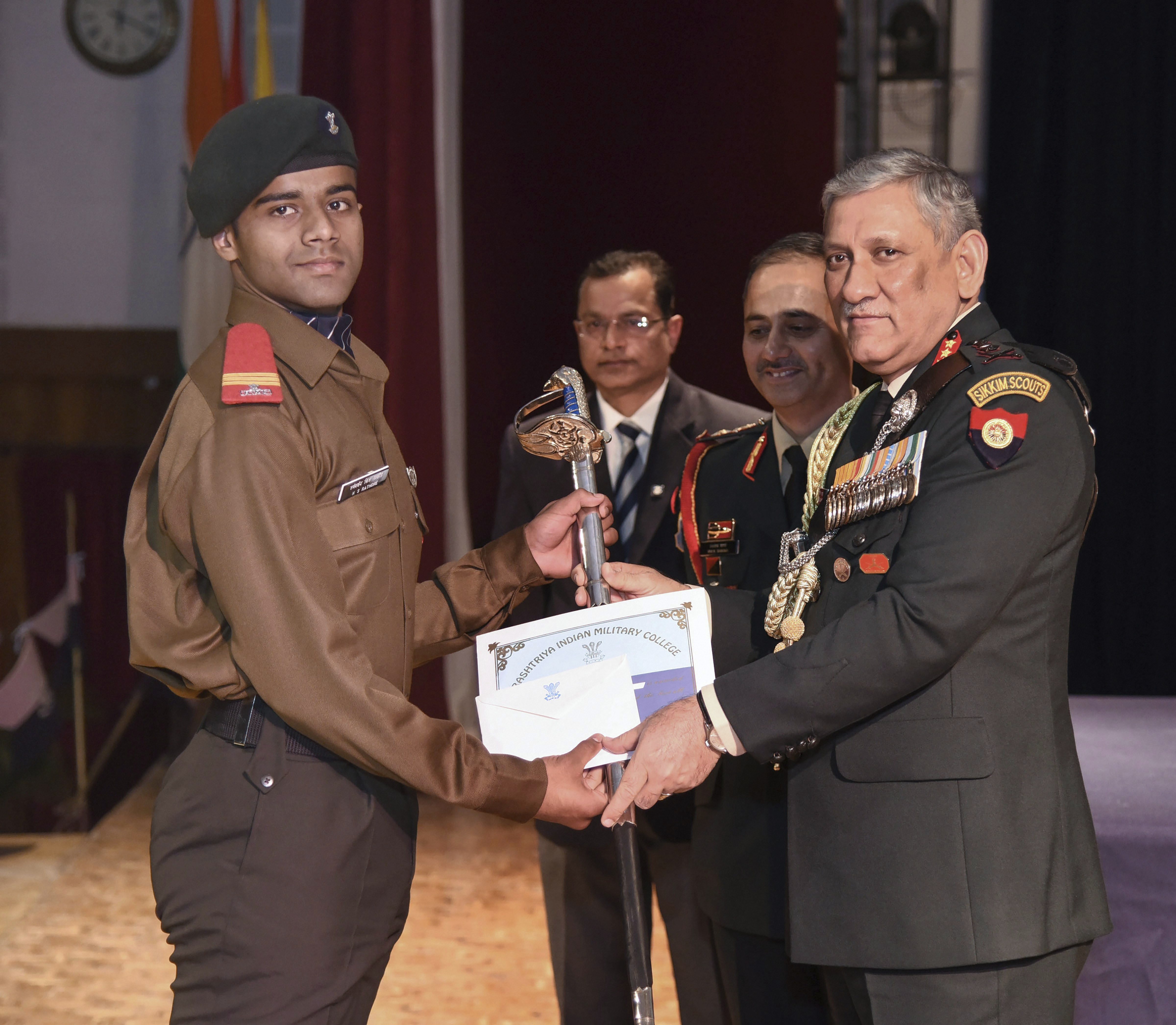 Chief of Army Staff General Bipin Rawat gives away sword of honor to cadet captain on the occasion of the 184th graduation ceremony of RIMC, in Dehradun - PTI