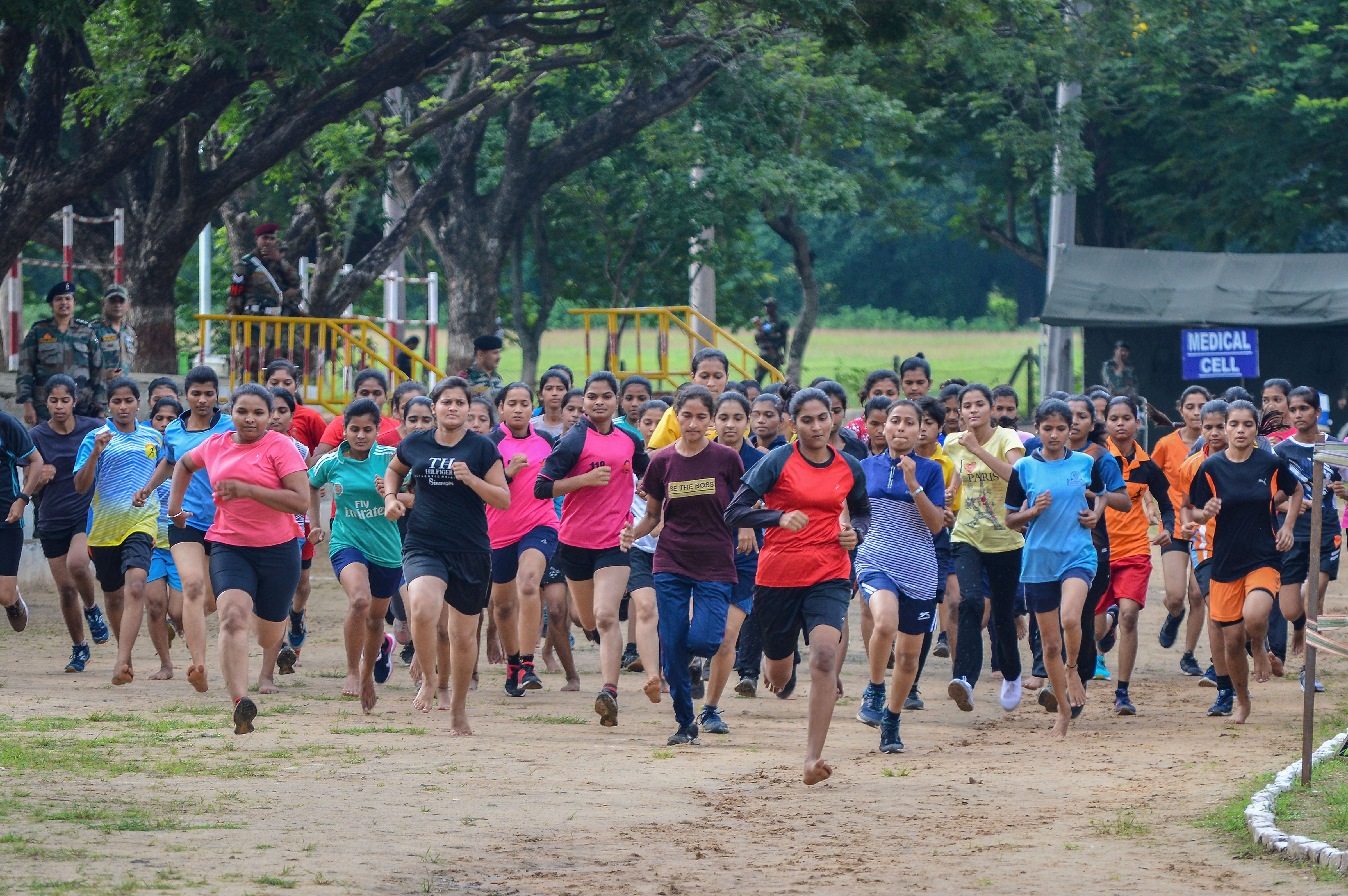 Women run as they participate in an army recruitment rally for women military police as soldiers for GD - PTI