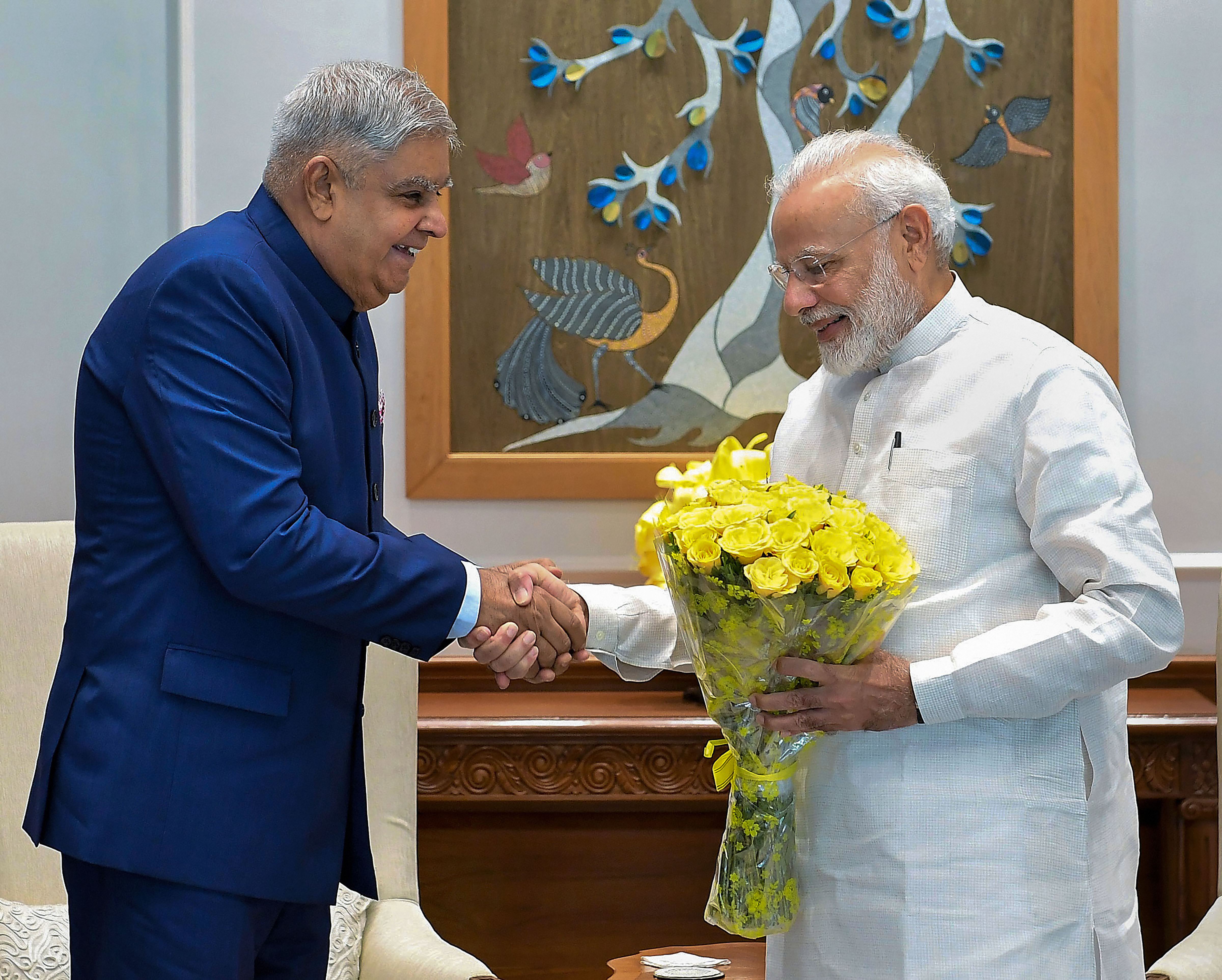 Prime Minister Narendra Modi shakes hands with West Bengal Governor Jagdeep Dhankhar during a meeting - PTI