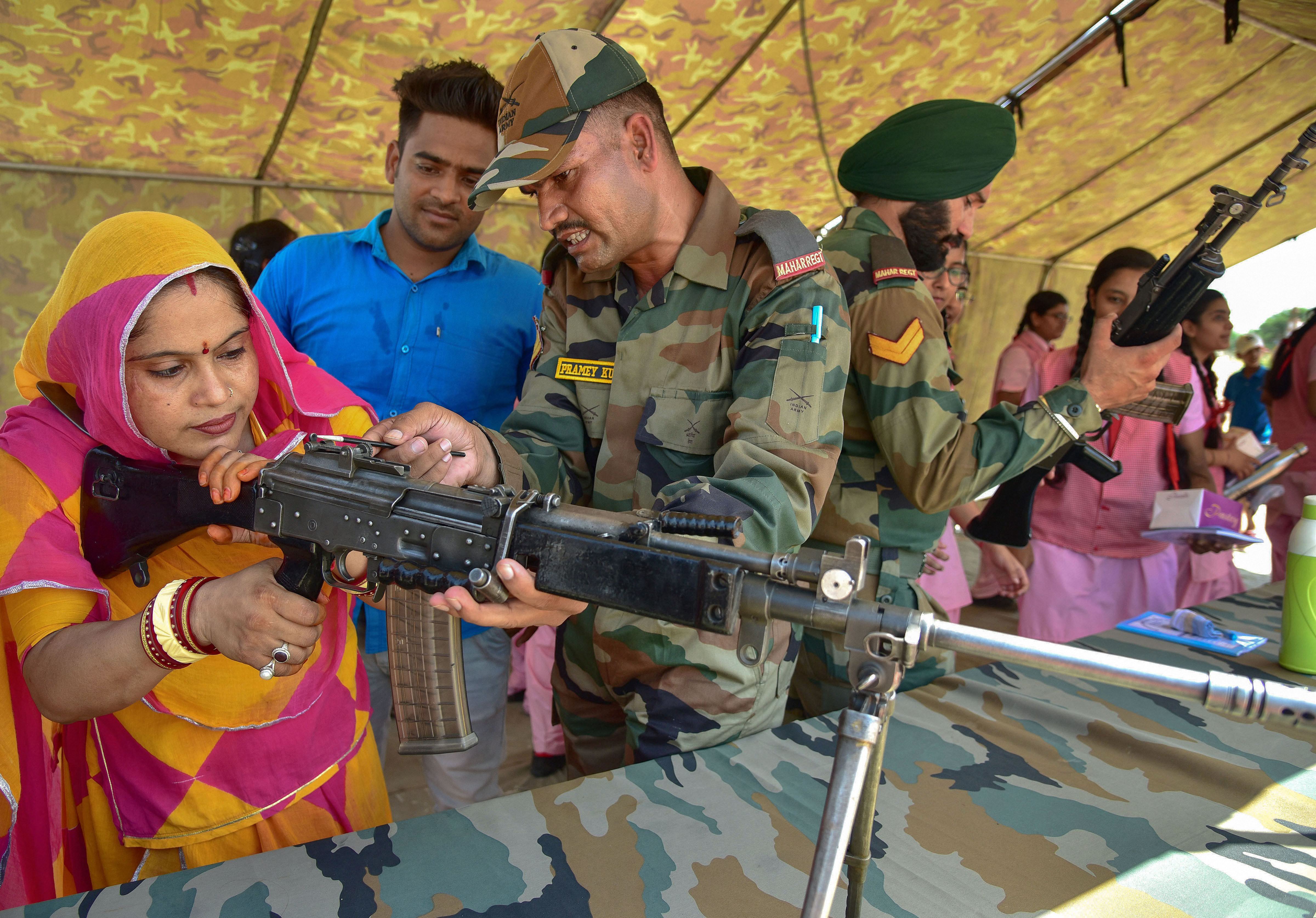 An army soldier guides a visitor during 'Know Your Army' exhibition in Bikaner - PTI