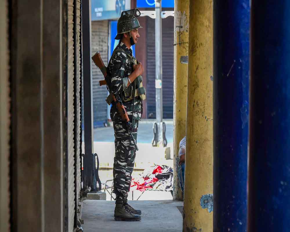 A security personnel stands guard during shutdown in Srinagar - PTI