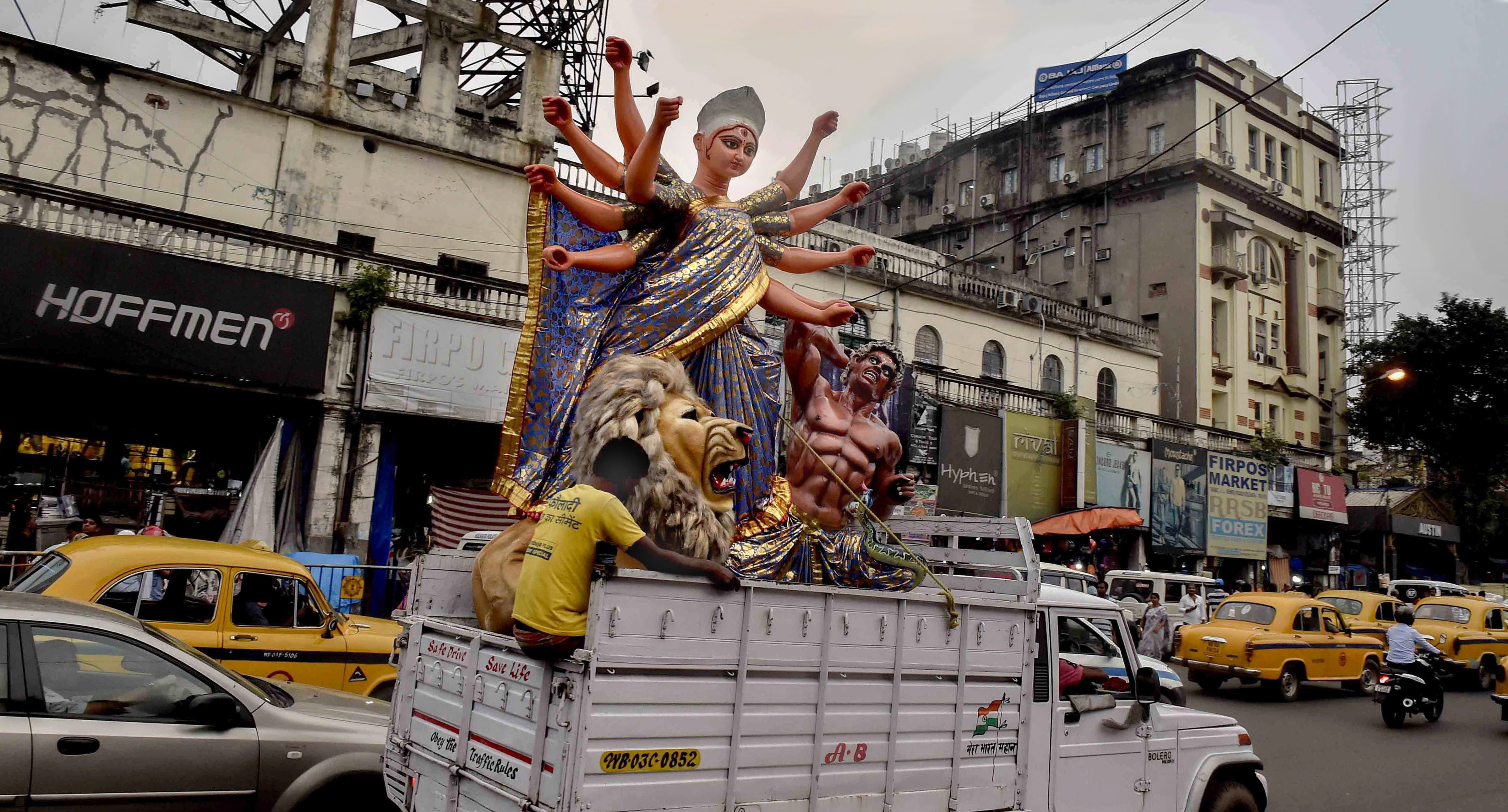 An idol of Goddess Durga is taken to a pandal for the installation ahead of Durga Puja festival in Kolkata - AP