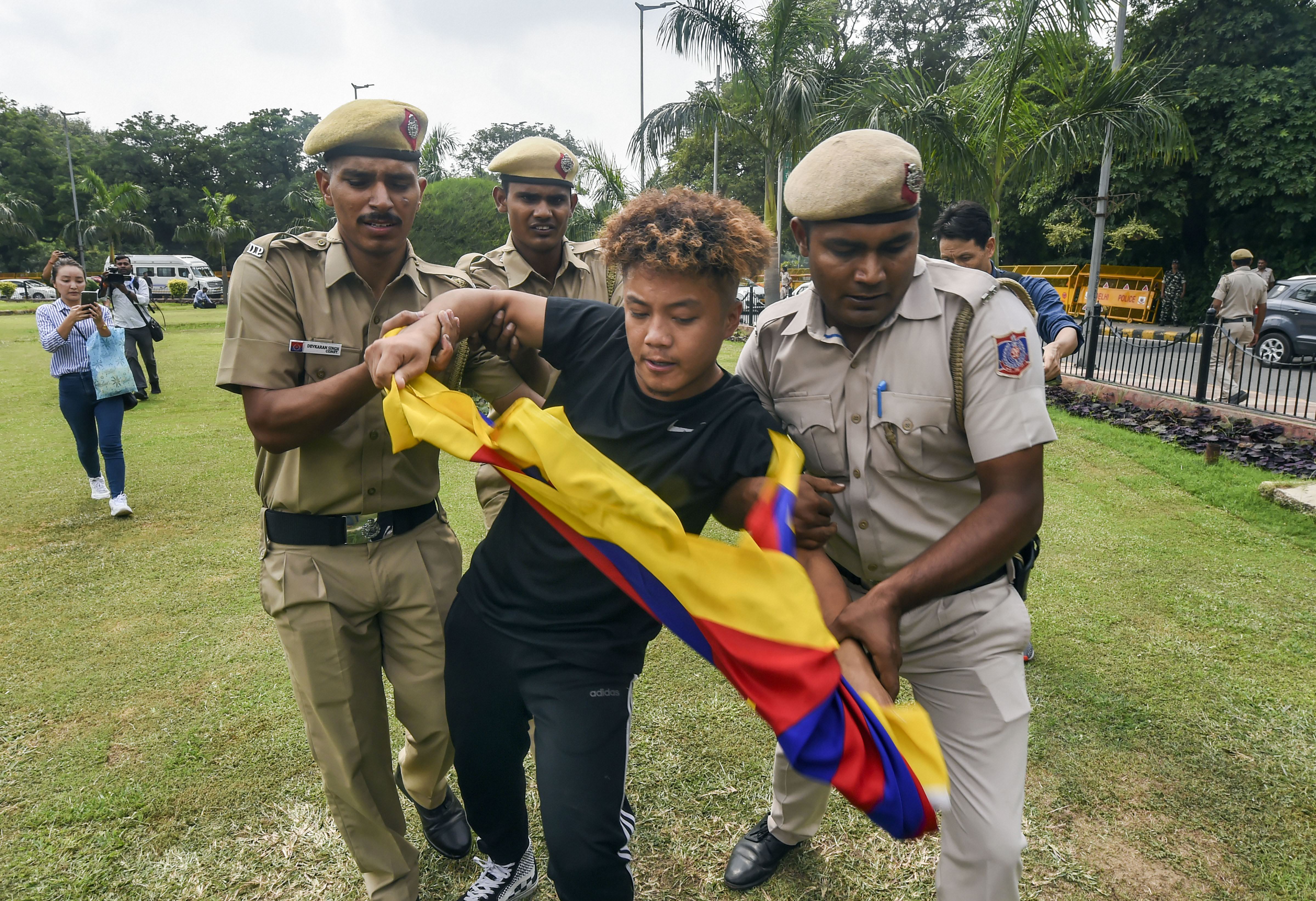 Police personnel detain Tibetan Youth Congress activists during their protest near the Chinese embassy in New Delhi - PTI