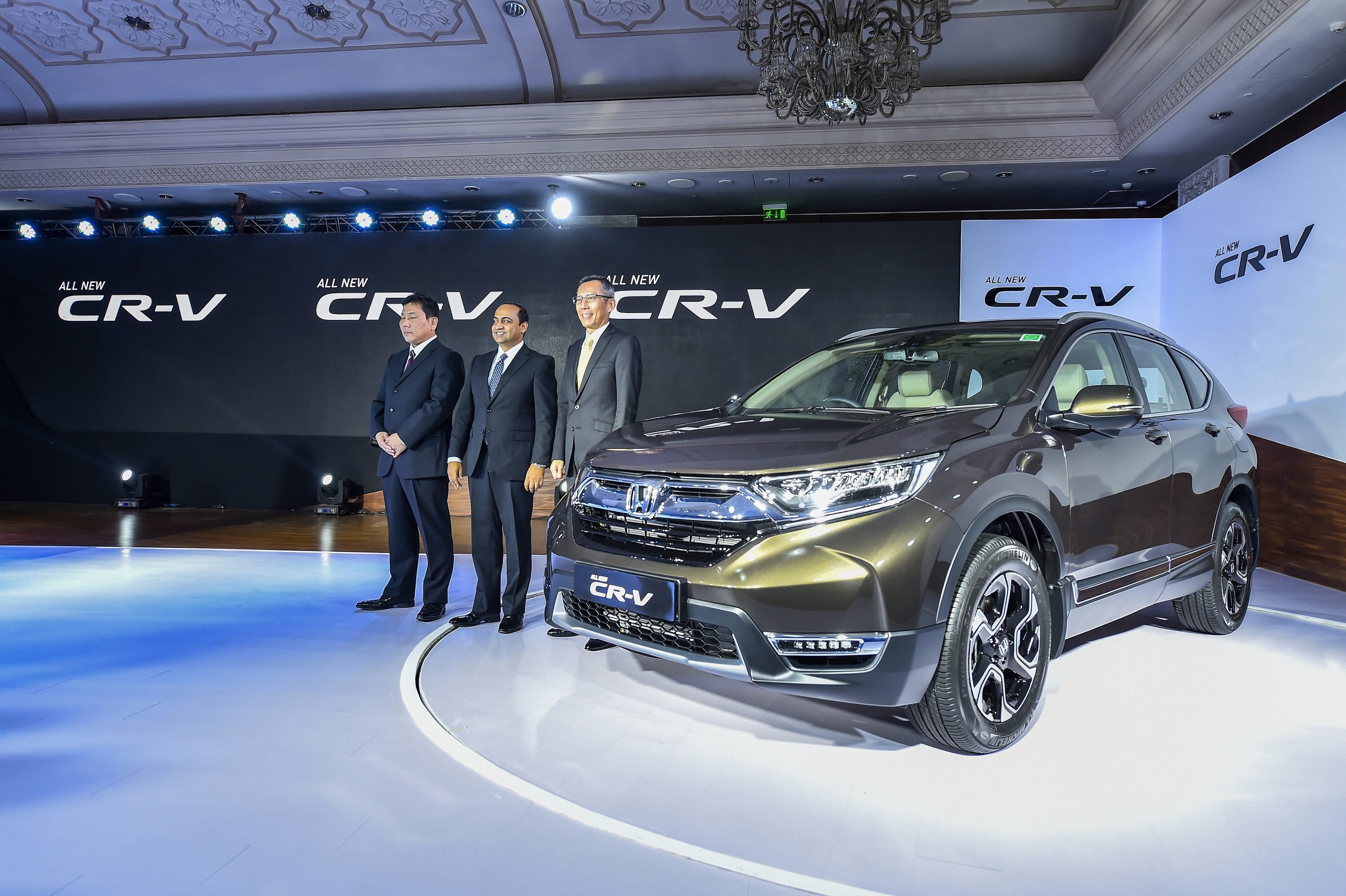 President & CEO of Honda Cars India, Gaku Nakanishi with Senior Vice President & Director-Marketing & Sales Rajesh Goel and Director, Sales & Marketing Makoto Hyoda poses for photographs at the launch of the all-new Honda CR-V, in New Delhi - PTI